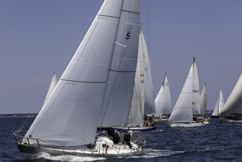 Sur le plan d'eau de Noirmoutier, s'est déroulé du 01 au 03 aout 2025 la régate Noirmoutier Classic. La régate regourpe une flotte de grands cloassiques dont Les 4 Pen Duick, et de nombreuses unités du YCC, ainsi qu'une flotte de métrique (8mJI, 6mJI, 5.5MJ), Requin, Dragon et petits classiques. Le 03/08/2025 les images sont prises à partir du bord de Pen Duick III skippé par Benoit Hochard,  au milieu de la flotte des grands Classiques.A bord: Cécile, Adrien, Henri, Eliaz, Paul et Pierre.
